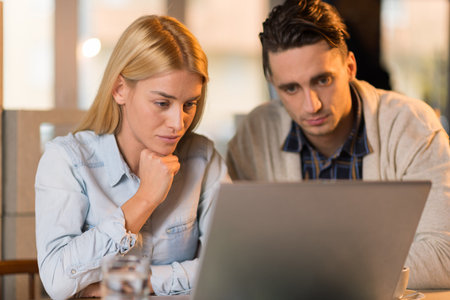 Worried business coworkers working together on computer in the office