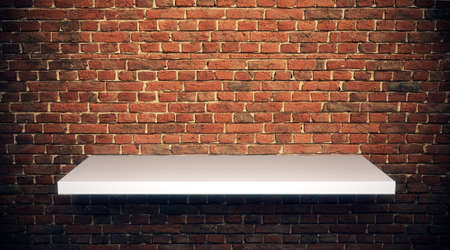 Blank space shelf waiting to be filled on a brick wallの写真素材