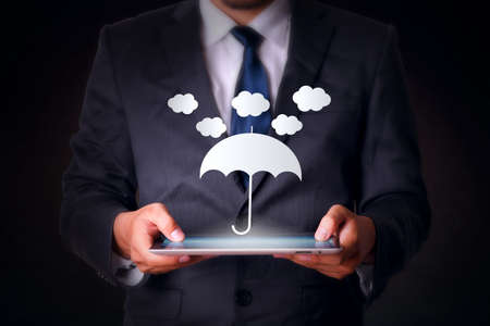 cloud and umbrella with tablet computer business technologyの写真素材