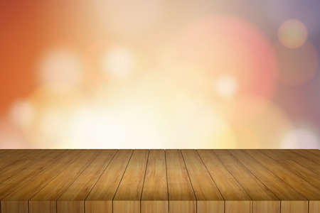 Wooden table in front of abstract blurred lights backgroundの写真素材
