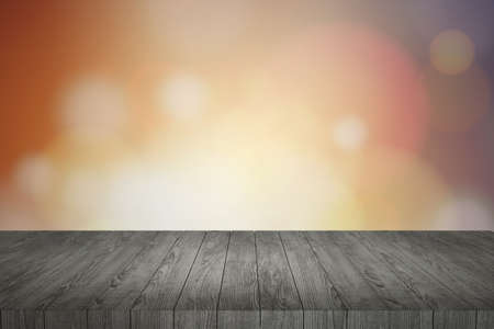 Wooden table in front of abstract blurred lights backgroundの写真素材