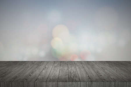 Wooden table in front of abstract blurred lights backgroundの写真素材