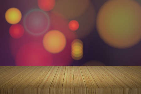 Wooden table in front of abstract blurred lights background,bokeh lights background.の写真素材