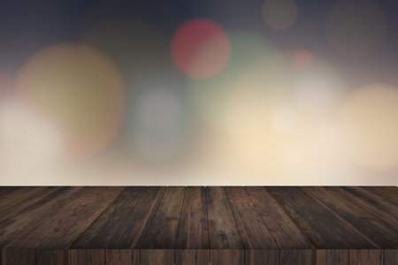 Wooden table in front of abstract blurred lights background
