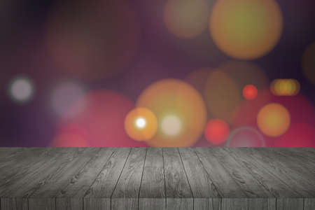 Wooden table in front of abstract blurred lights background,bokeh lights background.の写真素材