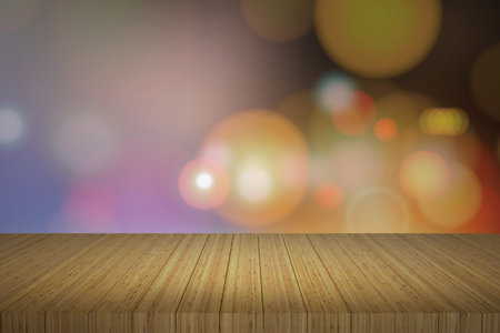 Wooden table in front of abstract blurred lights