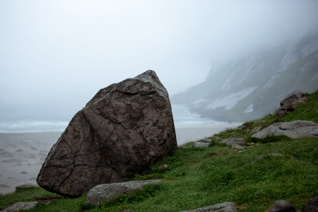Stone on the coast of Atlantic ocean in Norway. Foggy day.