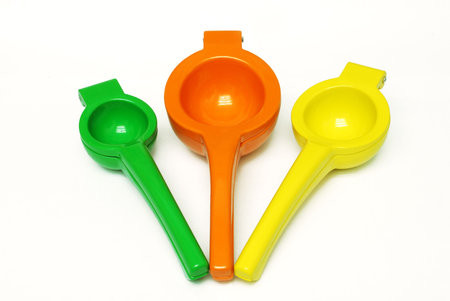 Lime, Orange, and Lemon squeezers on white background
