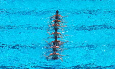 A seven women synchronized swimming team performing.の写真素材