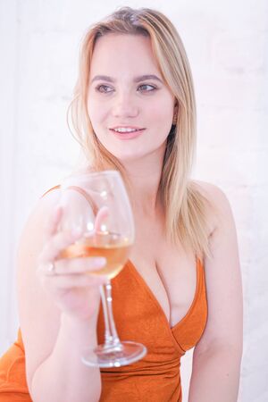 pretty plus size caucasian woman drink wine in the morning alone at homeの写真素材