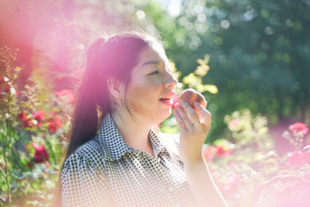 Asian girl resting in the summer in the Park in the intense heat in the bright sun alone