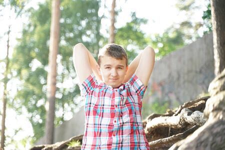 Portrait of a tired student of school. the boy wants to sleep in nature.の写真素材