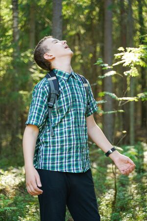 teenager boy lost alone in the countryside and scared in the forestの写真素材