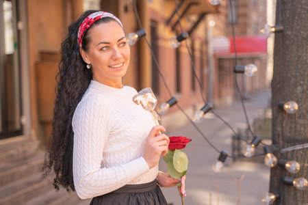 pretty happy caucasian woman walking in the city with lollipopの写真素材