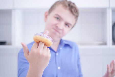 preteen handsome boy refuse to eat unhealthy foodの写真素材
