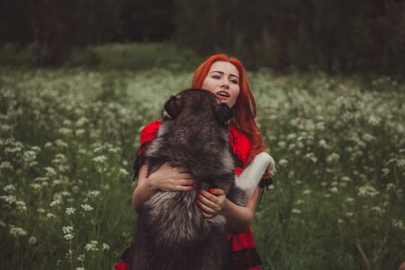 Girl with big grey dog on the nature background at summer time. Lifestyle photo.の写真素材