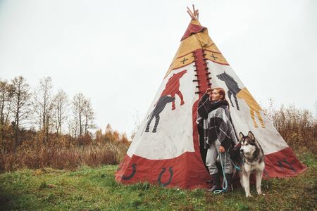 cute adult girl owner with her malamute gray big dog in the Injun campingの写真素材