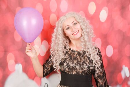 pretty christmas girl in black lace dress with purple air balloonの写真素材