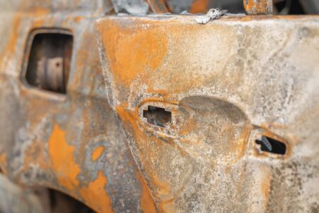 car after deliberate arson. destroyed vehicle after a fire melted is on the street.の写真素材