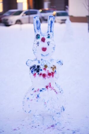 cute snowy snowman in the evening at the christmas city with nobodyの写真素材