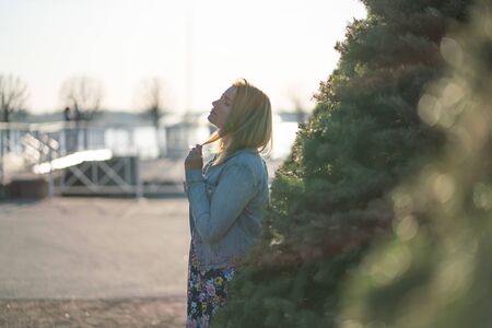 blond lovely plus size girl in dress in summer park on the nature aloneの写真素材