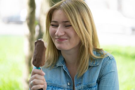 Girl eating ice cream and enjoy the summer outdoorの写真素材