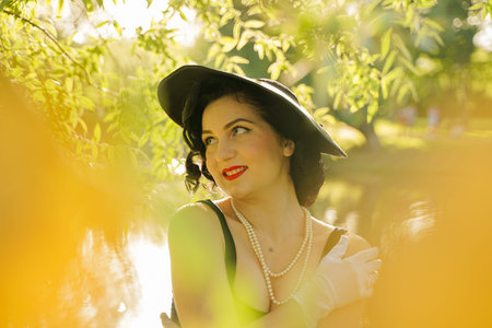 Sexy young pretty woman with vintage retro hat and seductive face outdoor