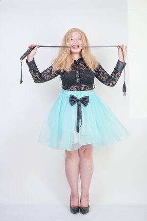 sexy hot plus size woman posing as bdsm mistress on white studio backgroundの写真素材