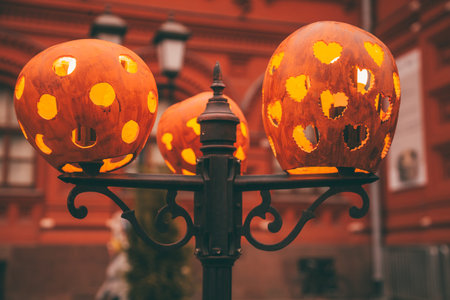 beautiful carved pumpkins put on a light bulb create a Halloween atmosphere. the lanterns Shine beautifully with warm light.の写真素材