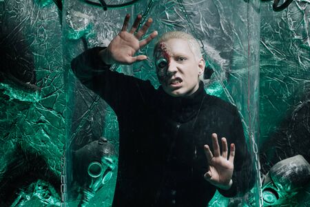 halloween make up. scary man ready for party. strange albino man with a piece of iron instead of a face portrays a robotの写真素材