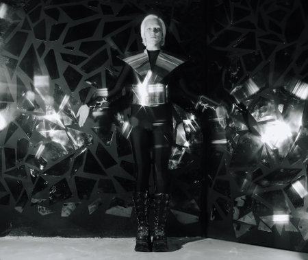 young blonde caucasian man standing in alien cosmos halloween costume and looking near the many...