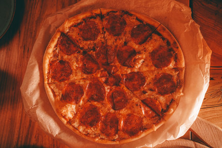 delicious fresh homemade pizza on the table. classic pepperoni pizza with sausage.