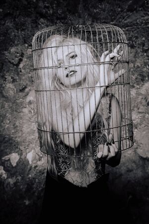 the woman voluntarily climbed into the cage. the psychology of a victim.の写真素材