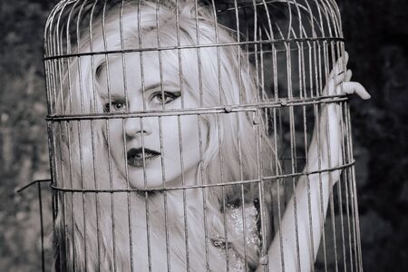 the woman voluntarily climbed into the cage. the psychology of a victim.の写真素材