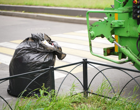 Green Garbage truck into waste emptying for waste disposal, Garbages creates environmental...