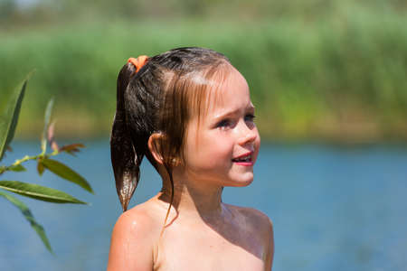 little girl bathes in lakeの写真素材
