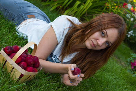 young girl sit on the grassの写真素材