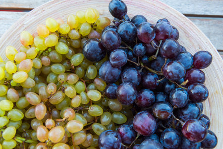 peaches and grapes in a plate on the table