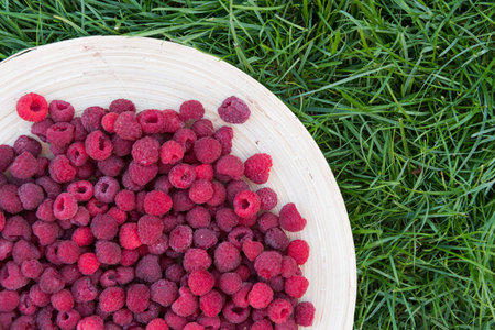 pile of raspberries in a bowl close up