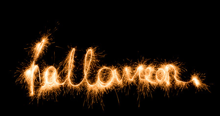 Halloween sign sparklers on black backgroundの写真素材