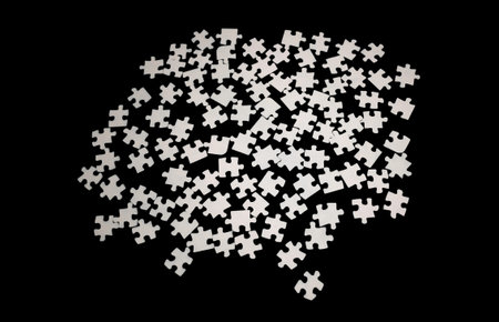 White, gray puzzles on a black background, footage. Puzzle