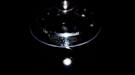 Drops on a transparent object, on a black background, an abstraction.