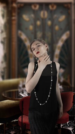 Retro photography, 1920 style. Girl in a black dress, hair waves. The background is out of focus.