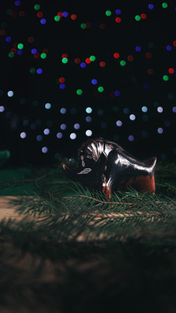 Christmas composition. Christmas gift, brown glass bull, spruce branches on a wooden table. Selective focus.の写真素材