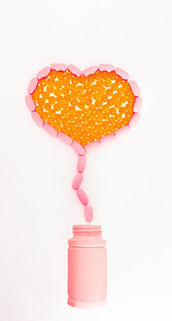 Vitamins of different types, yellow and peach color, in the form of a heart flying out of a plastic...