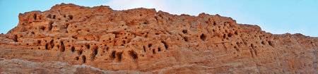 A mountain of quarry and river sand, in which the birds made nests. Mountain, canyon, nesting place...