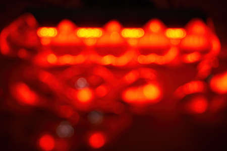 Red abstract background in defocus, glowing red and yellow lights, bokeh on a black background.の写真素材