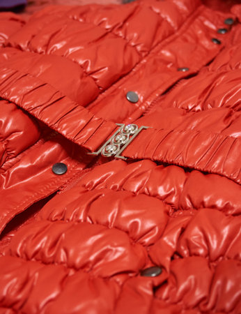 A red jacket with rivets and a belt with a close-up buckle. Soft selective selective focus, clothing...