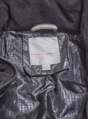 Black polyester lining close-up, Clean label. Folds and details of clothing. Soft selective focus.の写真素材