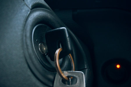 The car keys are inserted into the keyhole, the keys to start the car. Keys close-up.の写真素材